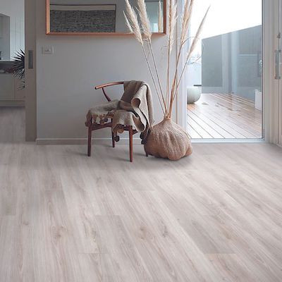 wood look laminate flooring in a hallway with wood chair and plant